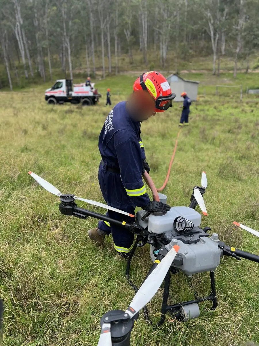 Refilling a fire-support drone between flights during a field exercise.