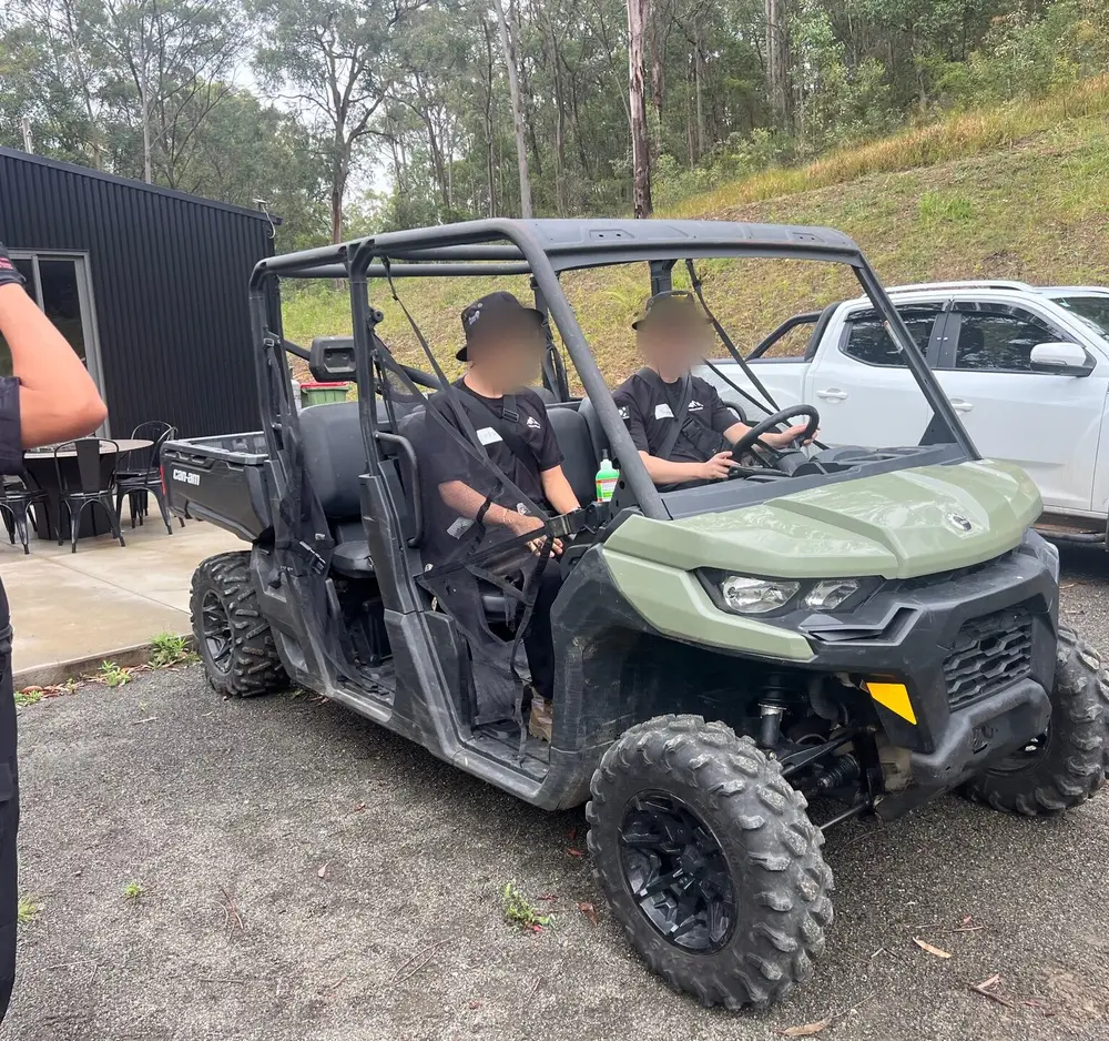 Trainees seated in a six-seat side-by-side buggy outside the lodge at the Hunter Valley base.