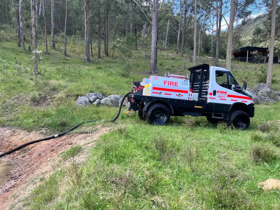 Firefighting appliance drafting water on site.