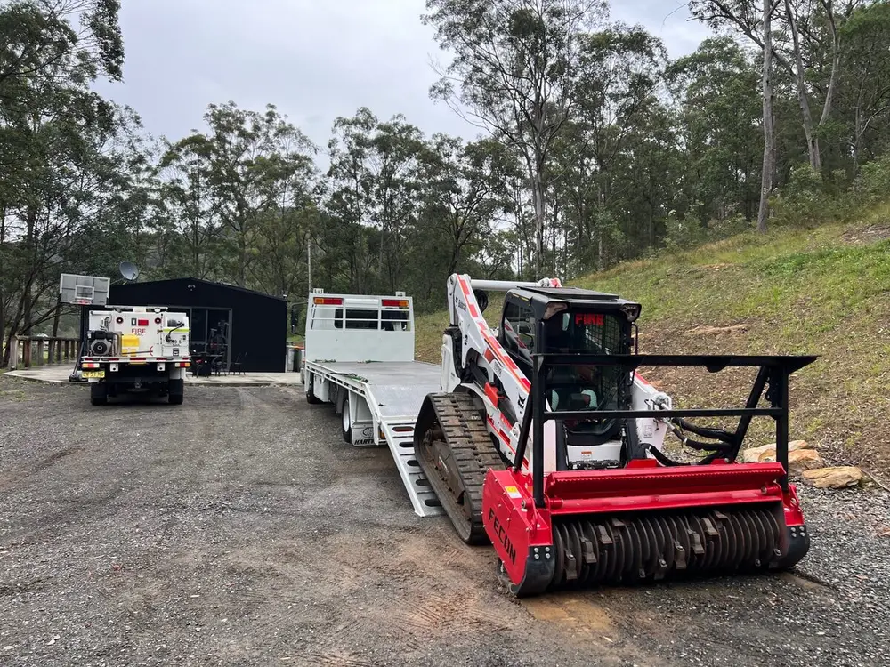 Tracked mulcher on the heavy transporter at the base, ready to move to a job.