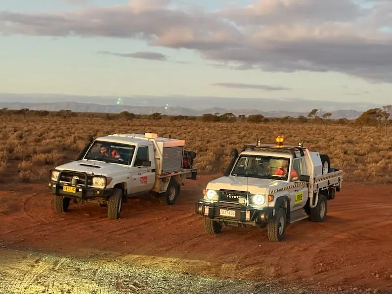 Traccorp response vehicles on a remote track at dusk.