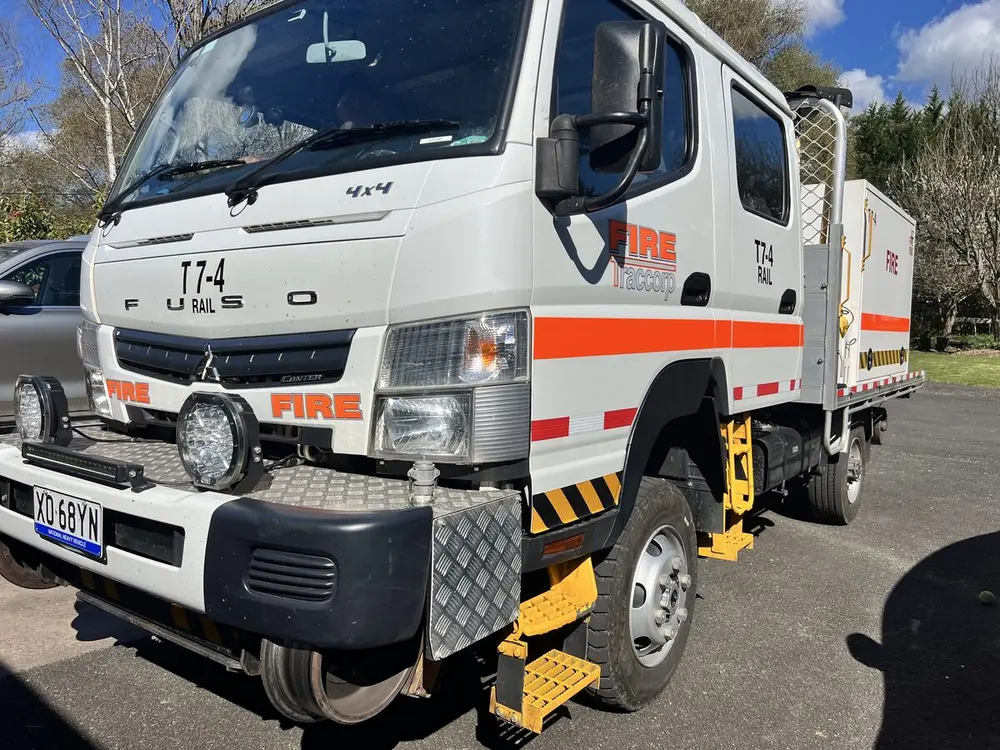 T7-4, a Fuso 4x4 crew-cab Hi-Rail tanker, with its rail guidance wheels raised.