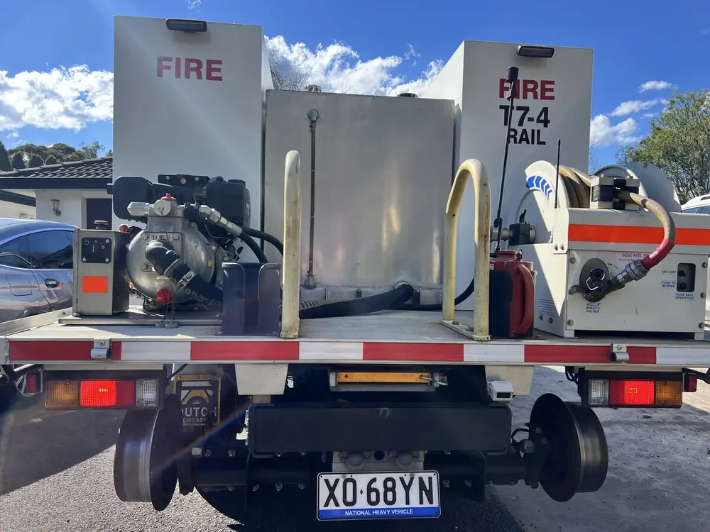 The rear deck of T7-4: pump, hose reel and tank, with the rear rail wheels below.